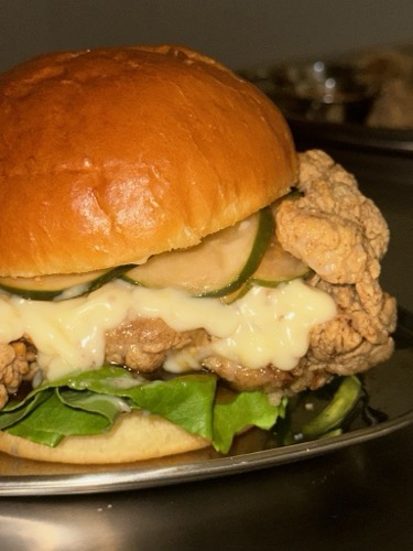 Classic Buttermilk fried chicken sandwich with apple jam, French mayo and pickles on a toasted brioche bun